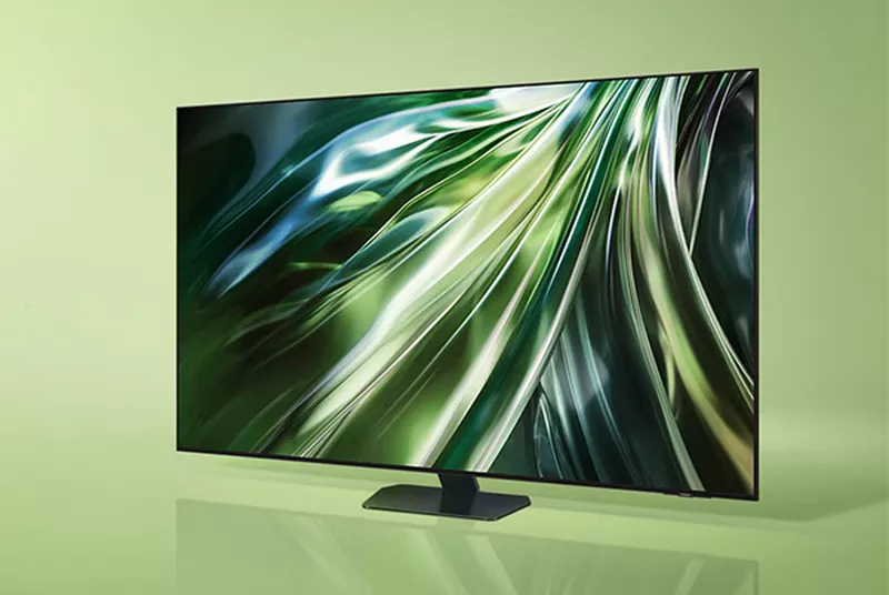 a samsung qn90d tv with a green screen on a green background